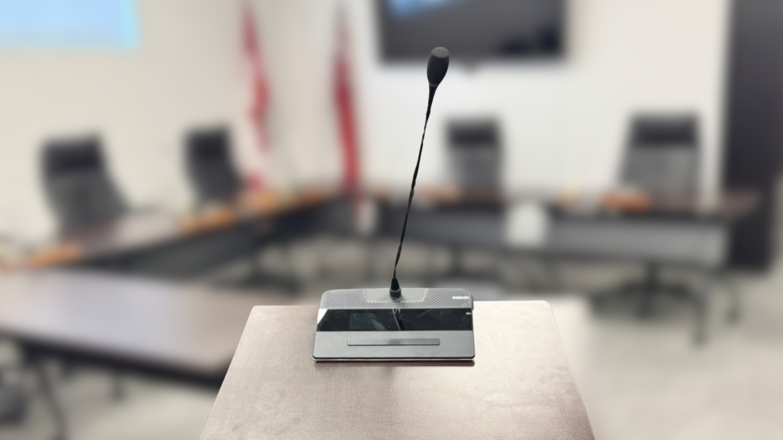 a microphone on a podium in Council Chambers